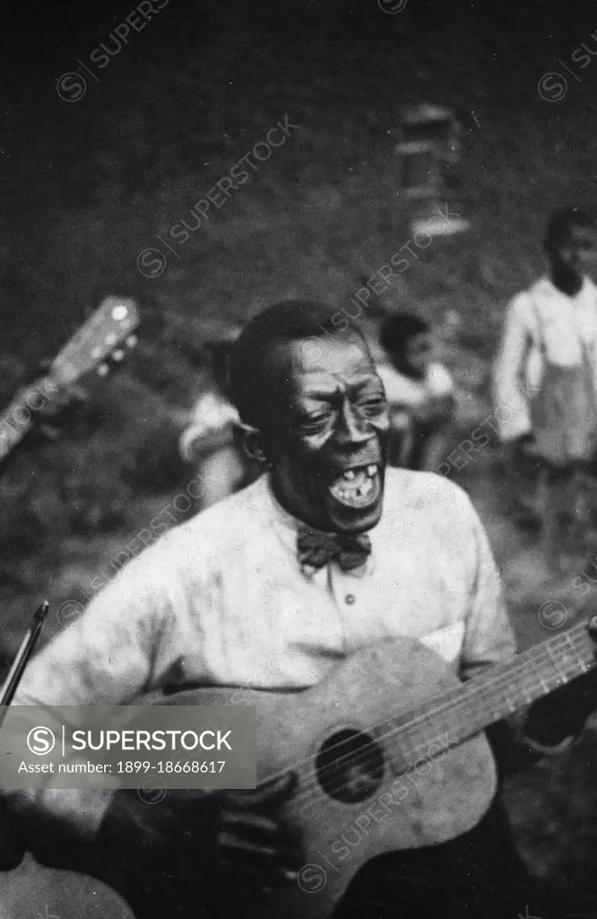 Stavin' Chain playing guitar and singing the ballad 'Batson,' Lafayette, La. June 1934.