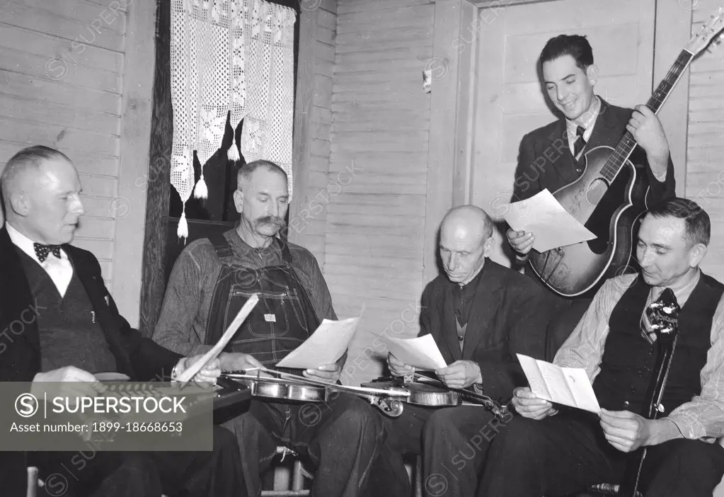 Bog Trotters Band members seated with instruments, Galax, Va. Includes Doc Davis, with autoharp; Crockett Ward, with fiddle; Uncle Alex Dunford, with fiddle; Wade Ward, with banjo; Fields Ward, with guitar circa 1937.