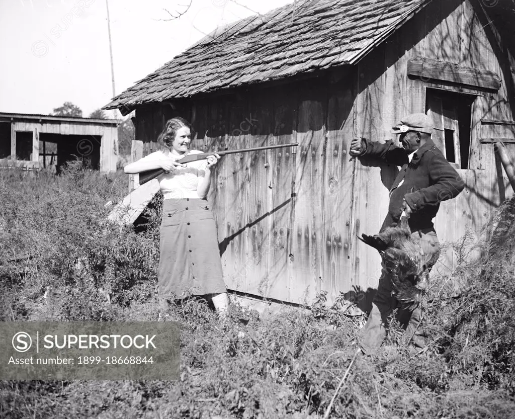  Edna Morris, who lives within a few hundred feet of the government-owned 'Tugwelltown' being constructed near Washington by Rehabilitation Administration, arms herself to protect her property against what she termed the 'thieving' of the workers on the project circa 10/15/1935.