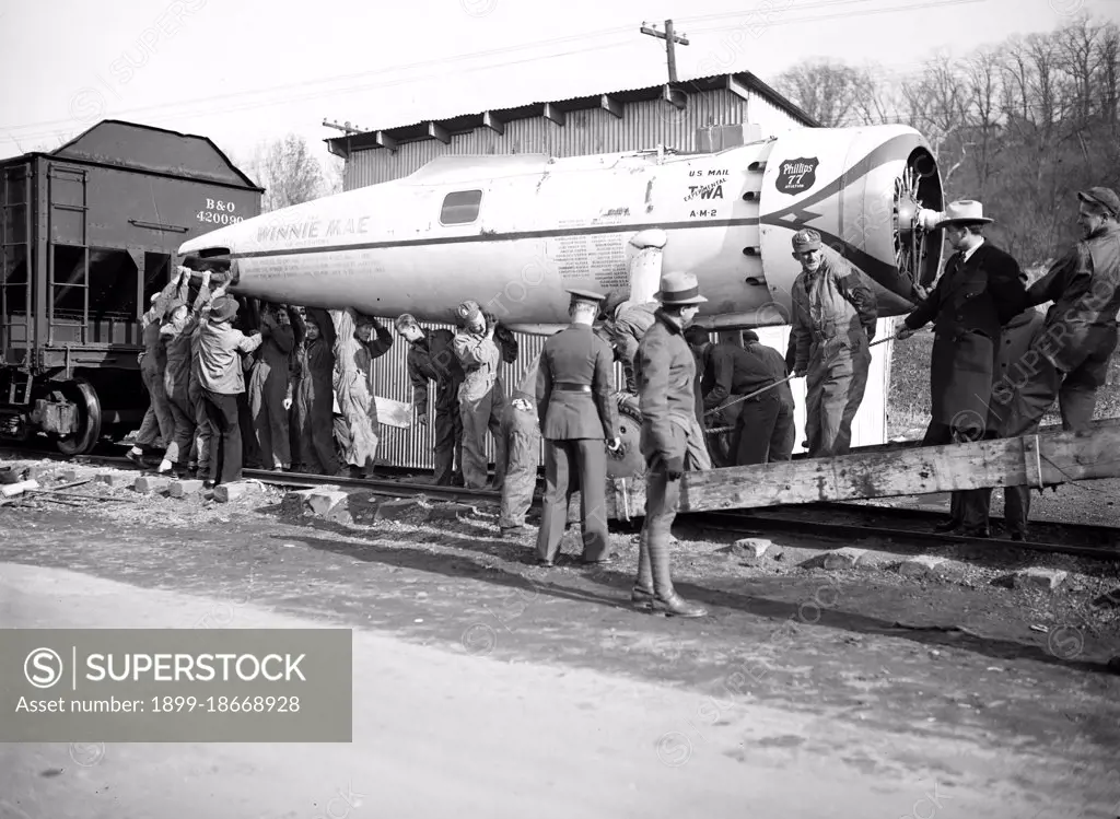 The Winnie Mae, famous globe circling plane with carried the late Wiley Post around the world solo is unloaded at Bolling field, Washington, under the direction of Smithsonian Institution circa 12/2/1935.