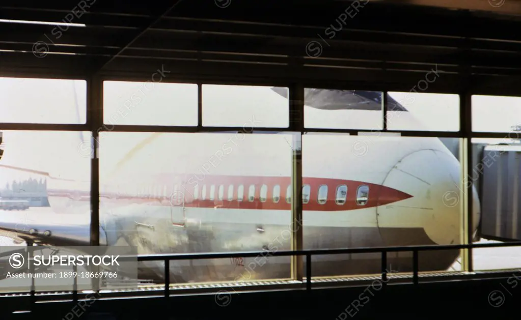 1972 France - (R) - Nose of a large airplane viewed through an airport terminal window circa 1972.