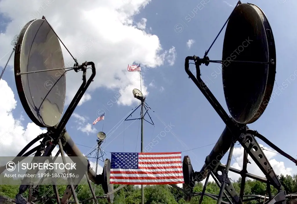 COMBINED ENDEAVOR 2000 - An American Flag hangs between two AN/TRC-170 Tactical Digital Tropospheric Scatter Radio parabolic antennas set up US Army (USA) 5th Signal Company deployed from Mannheim Germany.