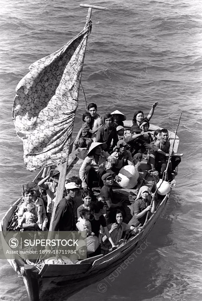 35 Vietnamese refugees wait to be taken aboard the amphibious command ship USS Blue Ridge. They are being rescued from a 35 foot fishing boat 350 miles northeast of Cam Ranh Bay, Vietnam, after spending eight days at sea. Boat people is a term that usually refers to refugees or asylum seekers who emigrate in numbers in boats that are sometimes old and crudely made. The term came into common use during the late 1970s with the mass departure of Vietnamese refugees from Communist-controlled Vietnam, following the Vietnam War. Many Vietnamese boat people - though not all - came from the south, the former Republic of Vietnam; also, many were Hoa or ethnic Chinese.