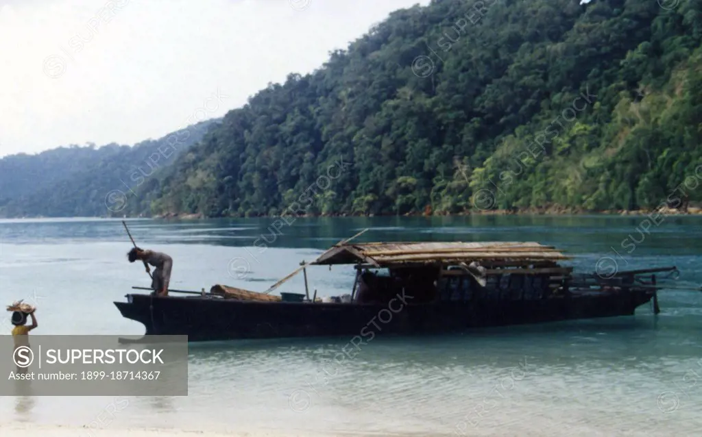 The Sea Gypsies’ or Moken of the Andaman Sea, known in Thai as chao thalae or people of the sea’, are divided into three groups. They number between 4,000 and 5,000, they live only on the coast, either in huts by the shore, or on craft that ply the coastal waters from the Mergui Archipelago in Burma to the Tarutao Islands in Southern Thailand. The largest Sea Gypsy group are the Urak Lawoi, numbering around 3,000. They live in simple shacks on beaches stretching south from Phuket to the Tarutao islands and make a living by fishing and beachcombing. Their two largest settlements are at Ko Sirey and Rawai in the southeast of Phuket island.