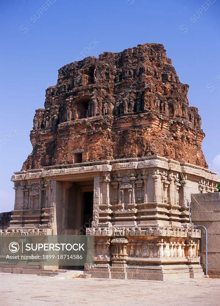 The Vittala Temple, built in the early 16th century, is devoted to the Hindu god Vithoba (also known as Vitthala and Panduranga), an incarnation of Vishnu or his avatar Krishna. Hampi is a village in northern Karnataka state. It is located within the ruins of Vijayanagara, the former capital of the Vijayanagara Empire. Predating the city of Vijayanagara, it continues to be an important religious centre, housing the Virupaksha Temple, as well as several other monuments belonging to the old city.