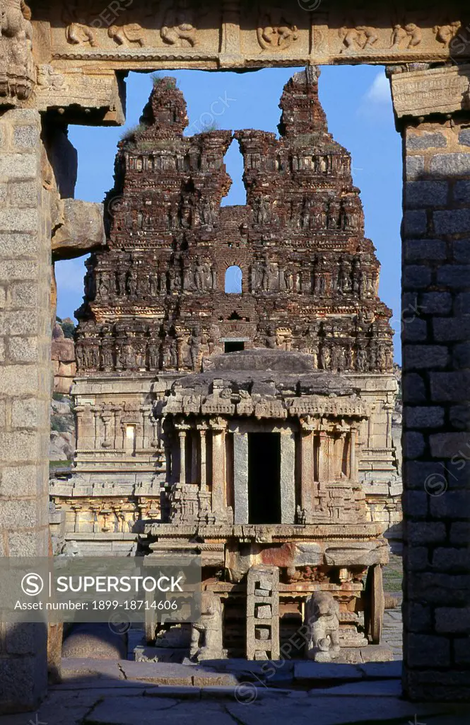 The Vittala Temple, built in the early 16th century, is devoted to the Hindu god Vithoba (also known as Vitthala and Panduranga), an incarnation of Vishnu or his avatar Krishna. Hampi is a village in northern Karnataka state. It is located within the ruins of Vijayanagara, the former capital of the Vijayanagara Empire. Predating the city of Vijayanagara, it continues to be an important religious centre, housing the Virupaksha Temple, as well as several other monuments belonging to the old city.