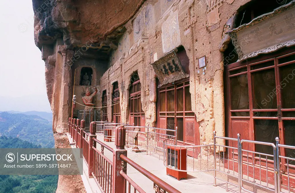 Maijishan Shiku (Maiji Shan Grottoes) are one of Chinas four most important Buddhist temple groups (the others being Datong, Luoyang, and the Mogao Caves at Dunhuang). Starting from the Northern Wei (386-535) and Northern Zhou (557-81) Dynasties, Buddhists cut caves into the sides of a red outcrop rising from the surrounding foliage-covered hills. Figures of the Buddha, of bodhisattvas and disciples were carved in harder rock brought from elsewhere, and installed in the caves. At their height, the Maijishan caves are believed to have numbered almost 800, but they suffered serious damage during an earthquake in 734. This event, combined with the exigencies of time, has reduced the number of extant caves to 194. The existing rock cut architecture contains over 7,200 Buddhist sculptures and over 1,000 square meters of murals. Maiji Shan translates literally as 'Wheatstack Mountain'.