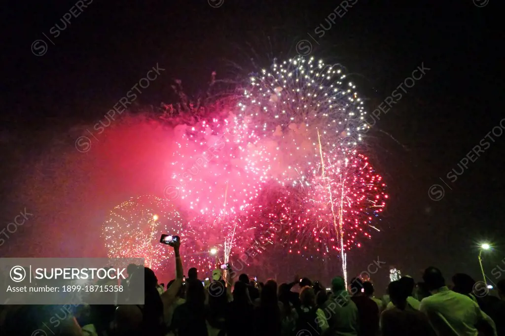 Crowds watching Macy's Fourth of July fireworks display, Manhattan.