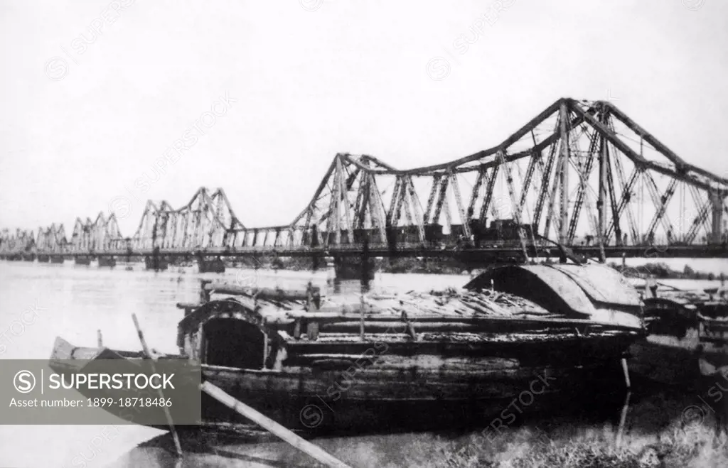 Long Bien Bridge was built in 1903 by the architects of Dayde & Pille, a French company. It is a historic cantilever bridge that spans the Red River, some 2.5 km in length. From 1899 to 1902, more than 3,000 Vietnamese took part in the construction. Before Vietnam's independence in 1954, it was called the Doumer Bridge after Paul Doumer, the Governor-General of French Indochina and then French president. Defence of the bridge played a major role in the Vietnam War against the United States, as the bridge provided the only secure connection to the port of Haiphong. It was heavily bombarded and was rendered unusable for a year when, in May 1972, it fell victim to one of the first coordinated attacks using laser-guided 'smart bombs'. The defense of Long Bien Bridge continues to play a large role in Hanoi's self-image and is often extolled in poetry and song.