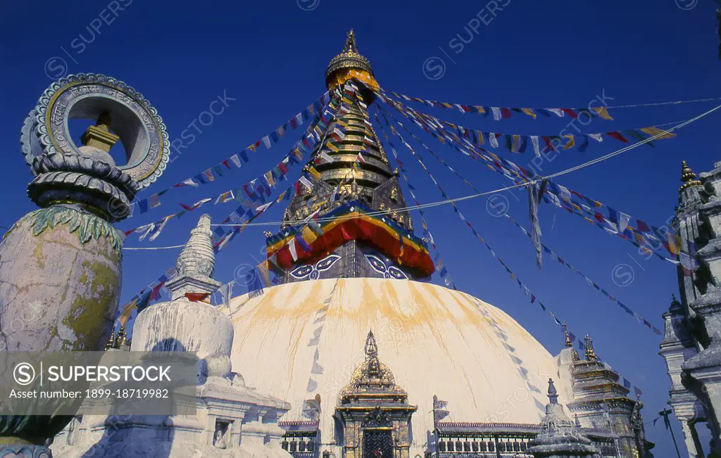 The date of construction of the Svayambhunath stupa, its origins steeped in myth, is unknown. According to the inscriptions on an ancient and damaged stone tablet at Svayambhunath, King Vrishadeva (ca. 400 CE) was the first to build a place of worship on the site. His grandson, King Manadeva I (ca. 464-505) may have made some additions. The Muslim invasion of 1349 undid all the pious building work, the marauding Muslim warriors dismantling every kafir (infidel) sanctuary that they came across. An inscription at Svayambhunath records the date of the Muslim invasion as 20 November 1349, in all probability a very accurate account. After the raids Svayambhunath was restored, and most of the buildings seen today are from the post-invasion period. Swayambhunath is an ancient religious complex atop a hill in the Kathmandu Valley, west of Kathmandu city. It is also known as the Monkey Temple as there are holy monkeys living in parts of the temple in the north-west. The Tibetan name for the sit