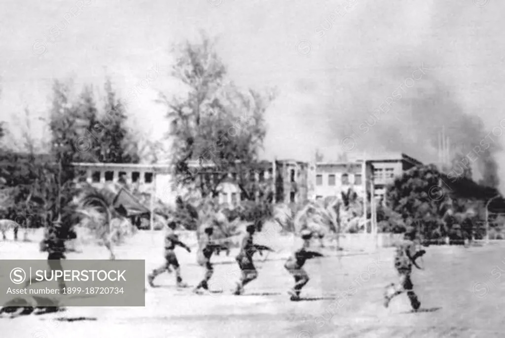 Rare image taken by a Vietnamese military photographer of Vietnamese soldiers advancing under fire into the heart of Phnom Penh. The depopulated city, inhabited only by Khmer Rouge leadership and forces, fell to the Vietnamese on January 7, 1979. The Khmer Rouge, or Communist Party of Kampuchea, ruled Cambodia from 1975 to 1979, led by Pol Pot, Nuon Chea, Ieng Sary, Son Sen and Khieu Samphan. It is remembered primarily for its brutality and policy of social engineering which resulted in millions of deaths. Its attempts at agricultural reform led to widespread famine, while its insistence on absolute self-sufficiency, even in the supply of medicine, led to the deaths of thousands from treatable diseases (such as malaria). Brutal and arbitrary executions and torture carried out by its cadres against perceived subversive elements, or during purges of its own ranks between 1976 and 1978, are considered to have constituted a genocide. Several former Khmer Rouge cadres are currently on trial