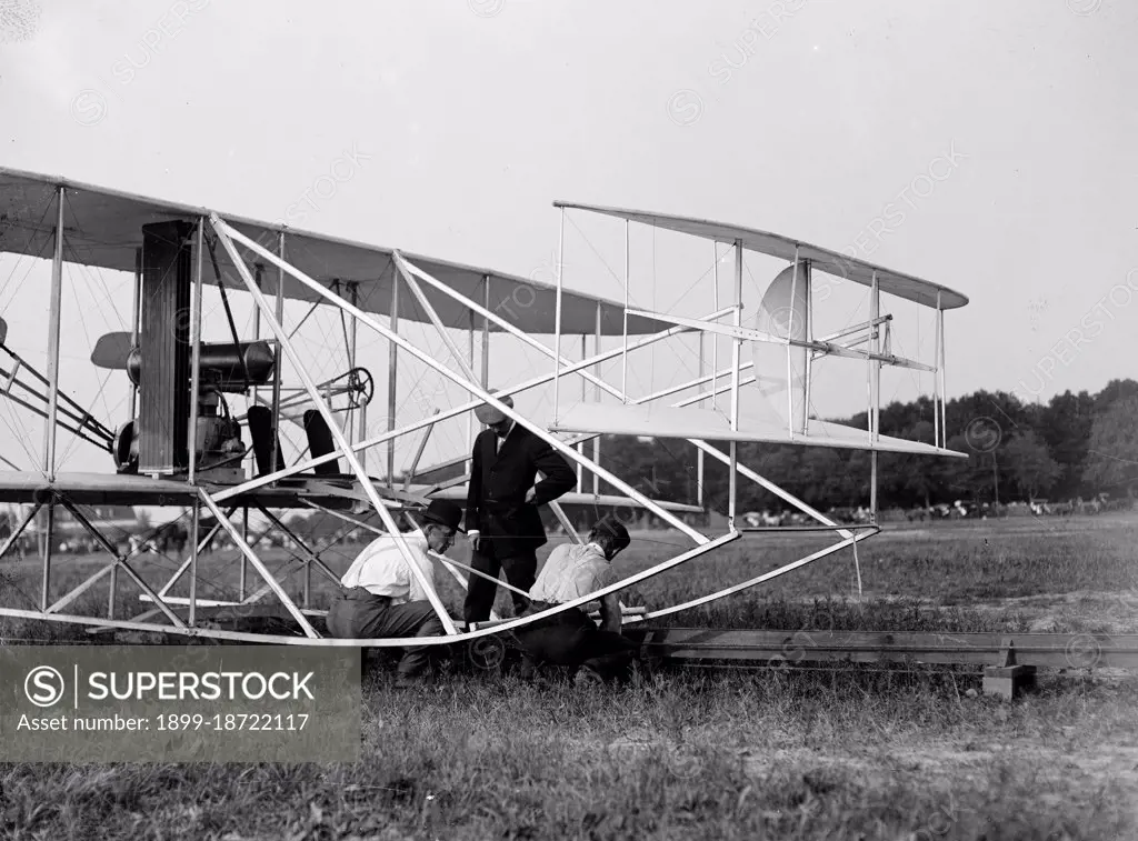 Wilbur Wright, Orville Wright and Charlie Taylor putting the plane on launching rail  Fort Myer Virginia circa 1909. 