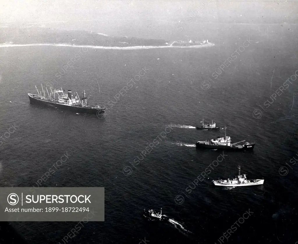 This photograph depicts an aerial view of the grounding of the American Packer in Hogs Island Channel, Cape Cod Massachusetts. 1957. 