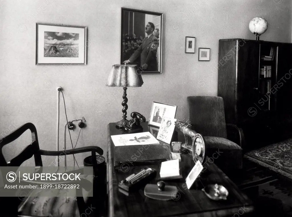 Possibly a Nazi officer's office and desk, hitler photo on wall circa late 1930s or early 1940s.