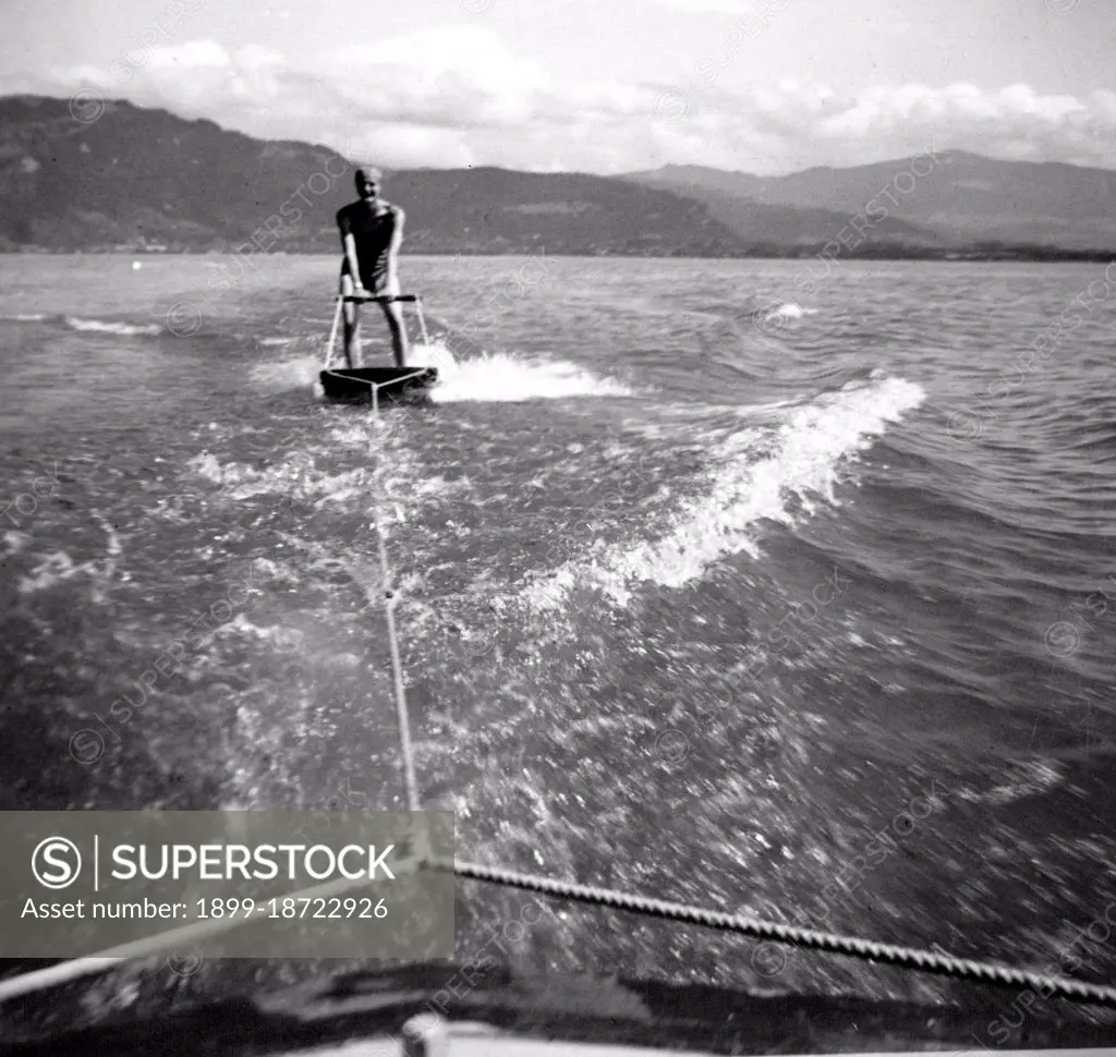 Man skiing behind boat on a board circa 1930s or early 1940s.