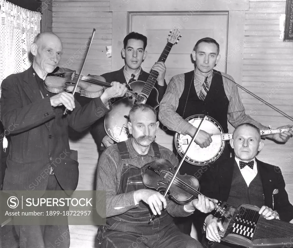 Members of the Bog Trotters Band, posed holding their instruments, Galax, Va. Back row: Uncle Alex Dunford, fiddle; Fields Ward, guitar; Wade Ward, banjo. Front row: Crockett Ward, fiddle; Doc Davis, autoharp circa 1937.