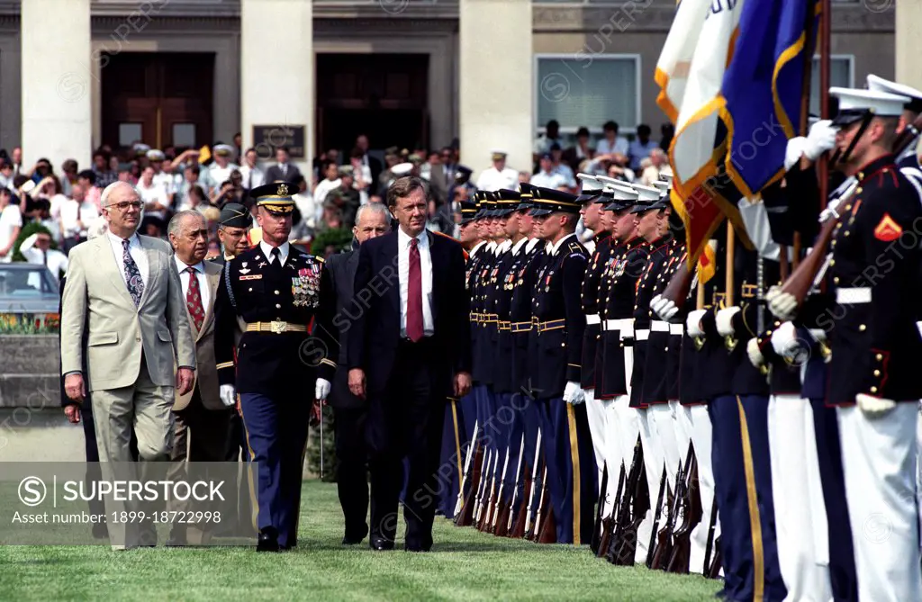 First row, left to right: the Honorable Secretary of Defense Les Aspin, Commander of Troops, the Honorable Bruce Babbitt, Secretary of the Interior.  Second Row, left to right: Individual unknown, the Honorable Marvin Runyon, Postmaster General, United States Postal Service.  Third row, General Colin Powell, Chairman, Joint Chief of Staff, pass through an honor cordon.