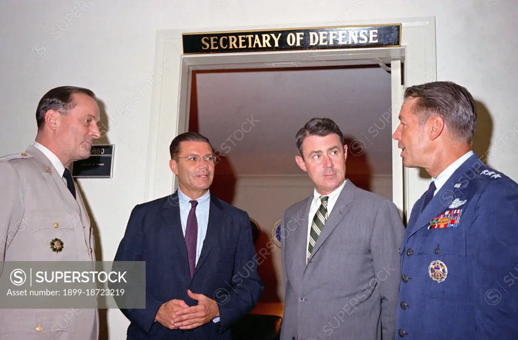 1960s - Secretary of Defense Robert S. McNamara holds a spontaneous conference outside his office at the Pentagon.  From left to right:  General Earle G. Wheeler, USA, chairman, Joint Chiefs of Staff (JCS); McNamara; Deputy Secretary of Defense Cyrus R. Vance; and Lieutenant General David A. Burchinal, USAF, director of the joint staff, JCS. 