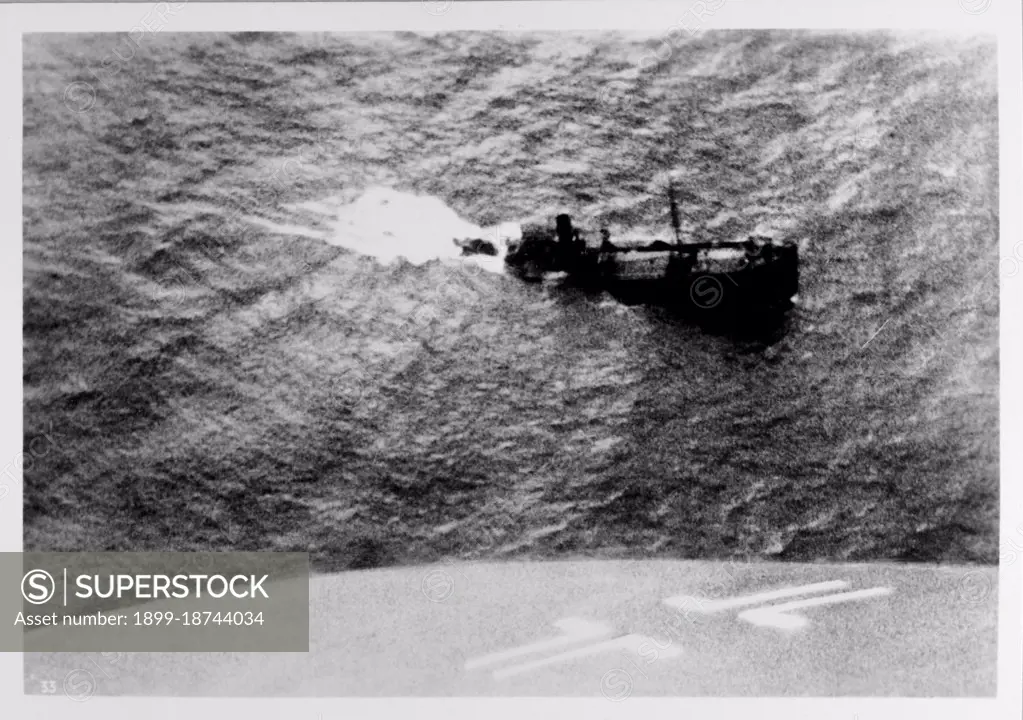 View of a British cargo ship as it sinks in the North Atlantic as taken by its German attacker. March 1940. 