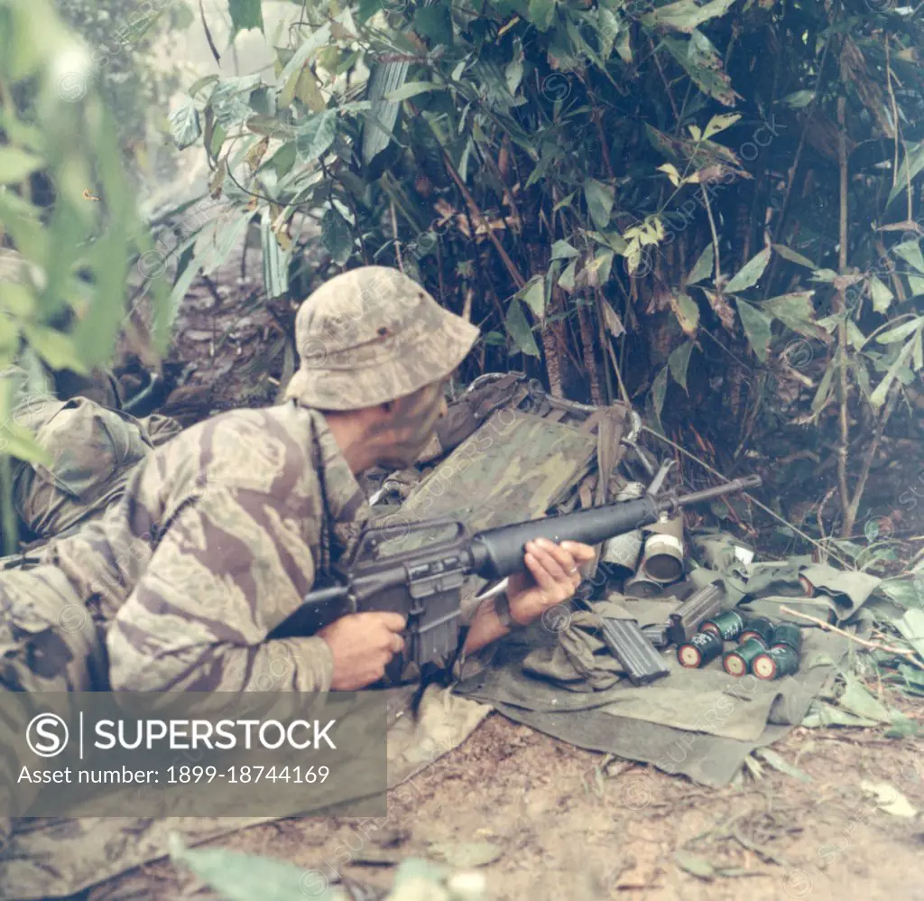 LRRP - Sgt Curtis E. Hester, Asst Patrol Leader, Co D, 151st Inf., opens fire with this M-16 rifle against the enemy. September 1, 1969, Vietnam. 