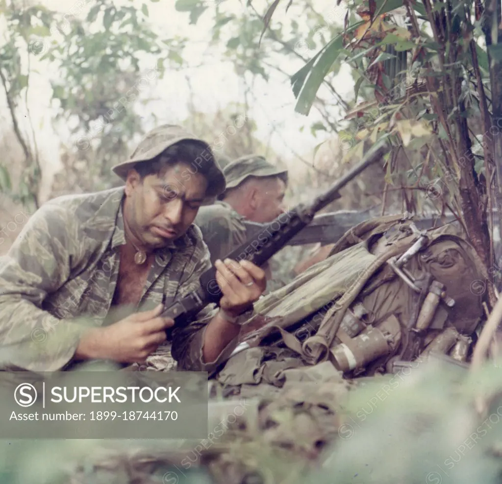 LRRP - Members of a Long Range Patrol Team open fire against the enemy. R-1 are: SP4 Salvador Romero, Senior Scout Observer, with M-16 and SSG James E. Wicks, Patrol Leader with M-60 machine gun. Vietnam, 19 September 1969. 