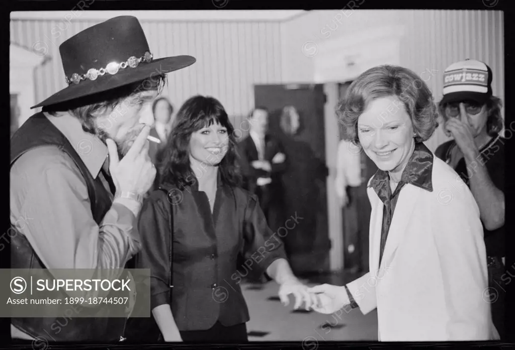 April 23, 1980 - First Lady Rosalynn Carter with Waylon Jennings, smoking a cigarette, and Jesse Colter at a reception preceding a concert to benefit the Carter-Mondale campaign.