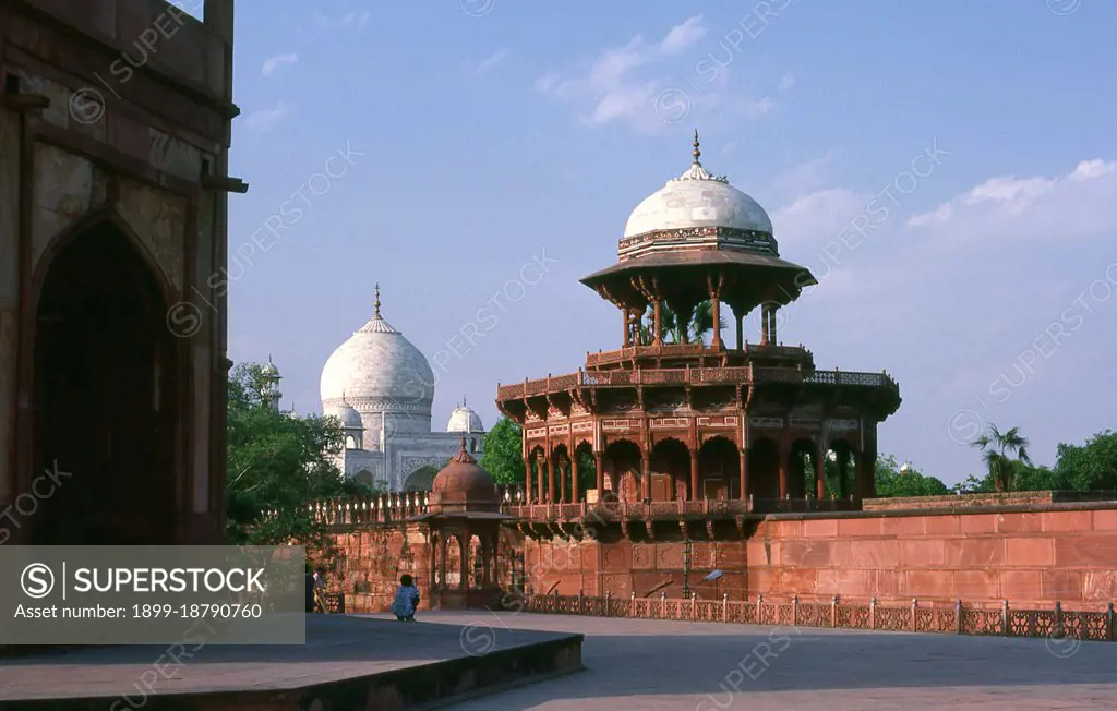 The Taj Mahal was built between 1632 and 1648 by Mughal emperor Shah Jahan (1592 - 1666) in memory of his third wife, Mumtaz Mahal. The Taj Mahal incorporates and expands on design traditions of Persian architecture and earlier Mughal architecture. Specific inspiration came from successful Timurid and Mughal buildings including; the Gur-e Amir (the tomb of Timur, progenitor of the Mughal dynasty, in Samarkand), Humayun's Tomb, Itmad-Ud-Daulah's Tomb (sometimes called the Baby Taj), and Shah Jahan's own Jama Masjid in Delhi. While earlier Mughal buildings were primarily constructed of red sandstone, Shah Jahan promoted the use of white marble inlaid with semi-precious stones, and buildings under his patronage reached new levels of refinement.