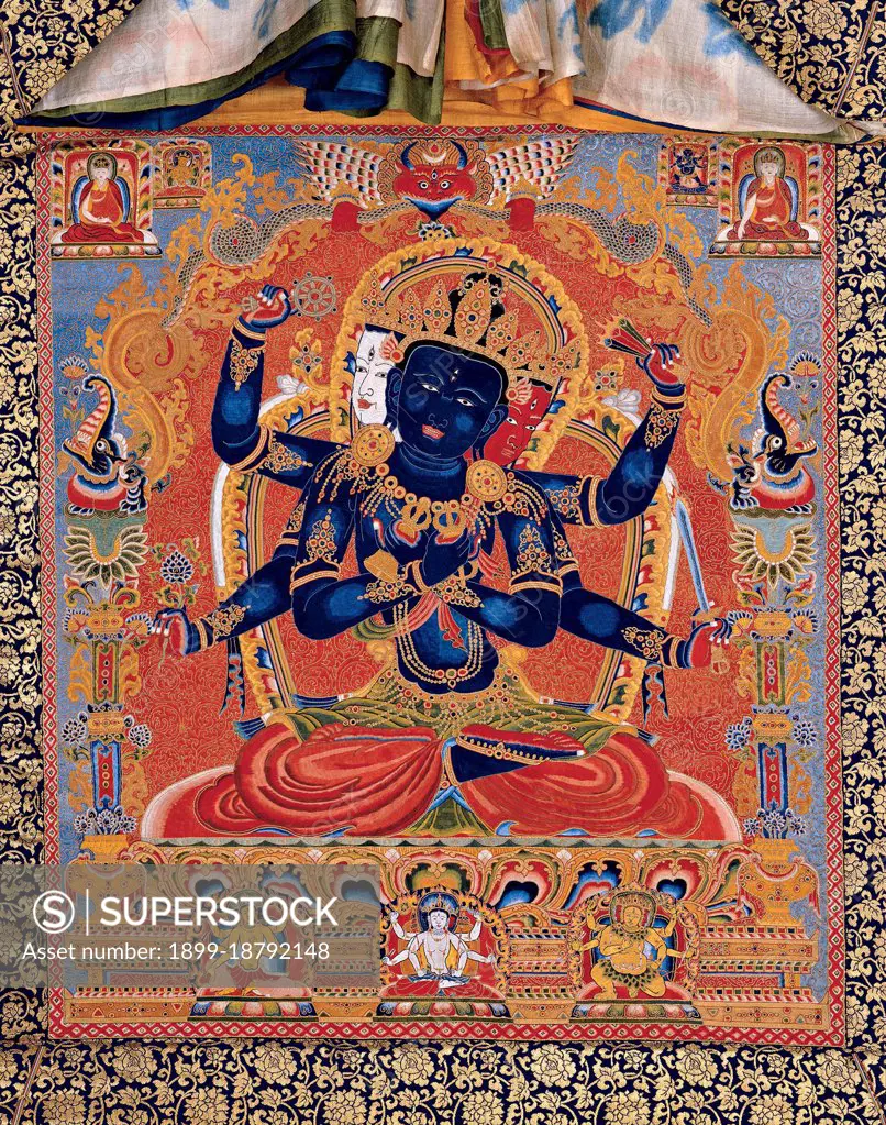 In the practice of the Guhyasamāja Tantra, the central deity of the Guhyasamāja is blue-black Akshobhyavajra, a form of Akshobhya, one of the five transcendent lords (pañcatathāgata). Akshobhyavajra holds a vajra and bell (ghanta) in his first two hands, and other hands hold the symbols of the four other transcendent lords: wheel of Vairocana and lotus of Amitabha in his right hands, and gem of Ratnasambhava and sword of Amoghasiddhi in his left hands. The maṇḍala consists of thirty-two deities in all.