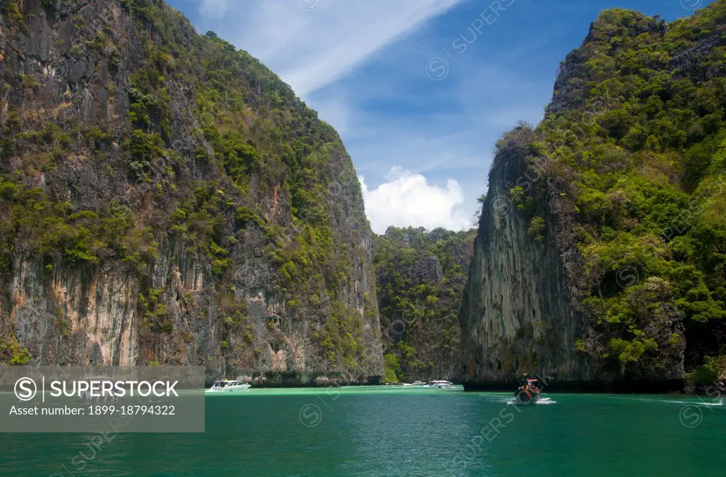 Ko Phi Phi consists of two islands, Phi Phi Leh and Phi Phi Don, located southeast of Phuket. Both are part of Hat Noppharat Thara Ko Phi Phi National Marine Park. Set in the centre of the Sea of Phuket, Ko Phi Phi is almost equidistant from Phuket and Krabi and can be reached by boat in around two hours. Phi Phi Don is the larger of the two islands, with scenic hills, steep cliffs, silken beaches, azure waters and remarkable bird- and sea-life. The island narrows at the middle where long, white-sand beaches are only a few hundred metres apart. Boats from Krabi and Phuket dock at Ao Ton Sai on the southern side of the island. Hat Yao or 'Long Beach' faces south and is famous for the good snorkelling to be had on its coral reefs. To the northeast Hat Lanti is another fine beach with good waves for surfing. North of this beach is beautiful Ao Bakao, a bay with a small resort, while near the tip of Laem Tong are three more luxury resorts.