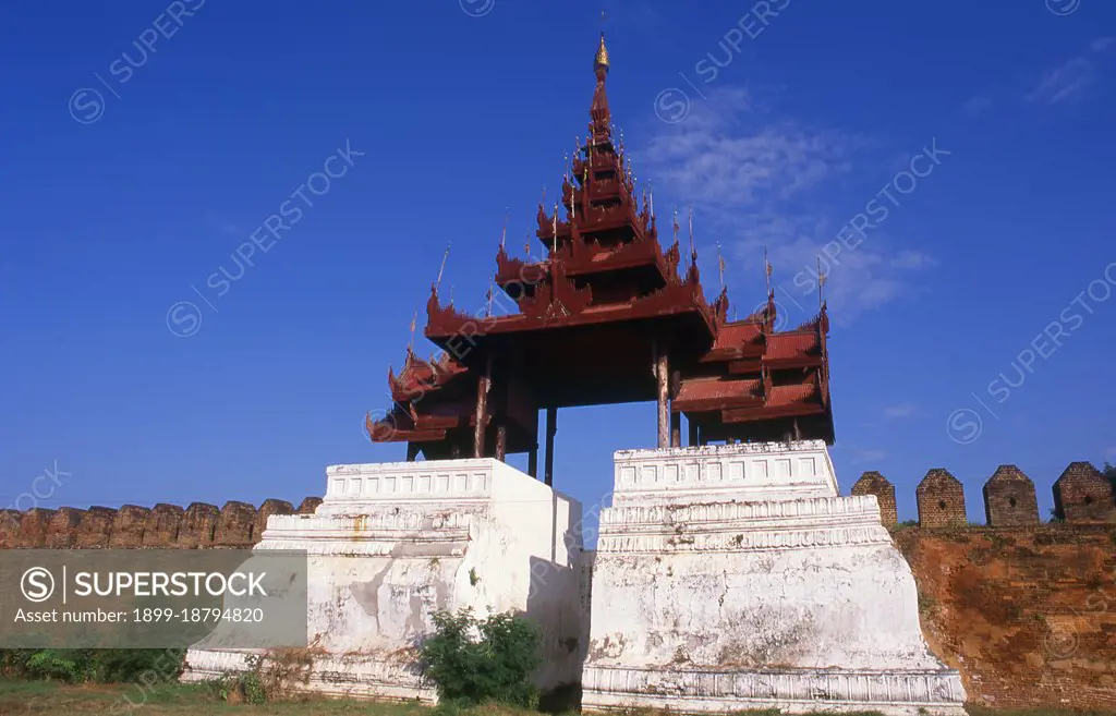 Mandalay Fort's almost 3km (2 miles) of walls enclose King Mindon's palace. The walls rise 8m (26ft). The palace was constructed, between 1857 and 1859 as part of King Mindon's founding of the new royal capital city of Mandalay. The plan of Mandalay Palace largely follows the traditional Burmese palace design, inside a walled fort surrounded by a moat. The palace itself is at the centre of the citadel and faces east. All buildings of the palace are of one storey in height. The number of spires above a building indicated the importance of the area below. Mandalay, a sprawling city of more than 1 million people, was founded in 1857 by King Mindon to coincide with an ancient Buddhist prophecy. It was believed that Gautama Buddha visited the sacred mount of Mandalay Hill with his disciple Ananda, and proclaimed that on the 2,400th anniversary of his death, a metropolis of Buddhist teaching would be founded at the foot of the hill.