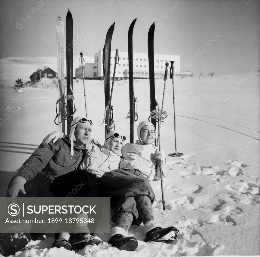 Finland History -  Three skiers chilling on snow, enjoying the sun in front of Hotel Pallas. ca. 1938 . 