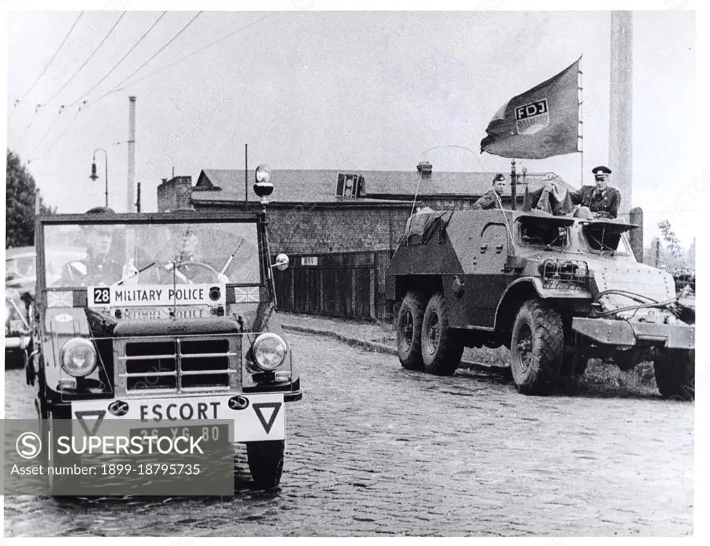 Berlin Wall Photo -  August 1961 - British Motorized Patrol Passes Communist East German Armored Car On A Street Bordering West and East Berlin.. 