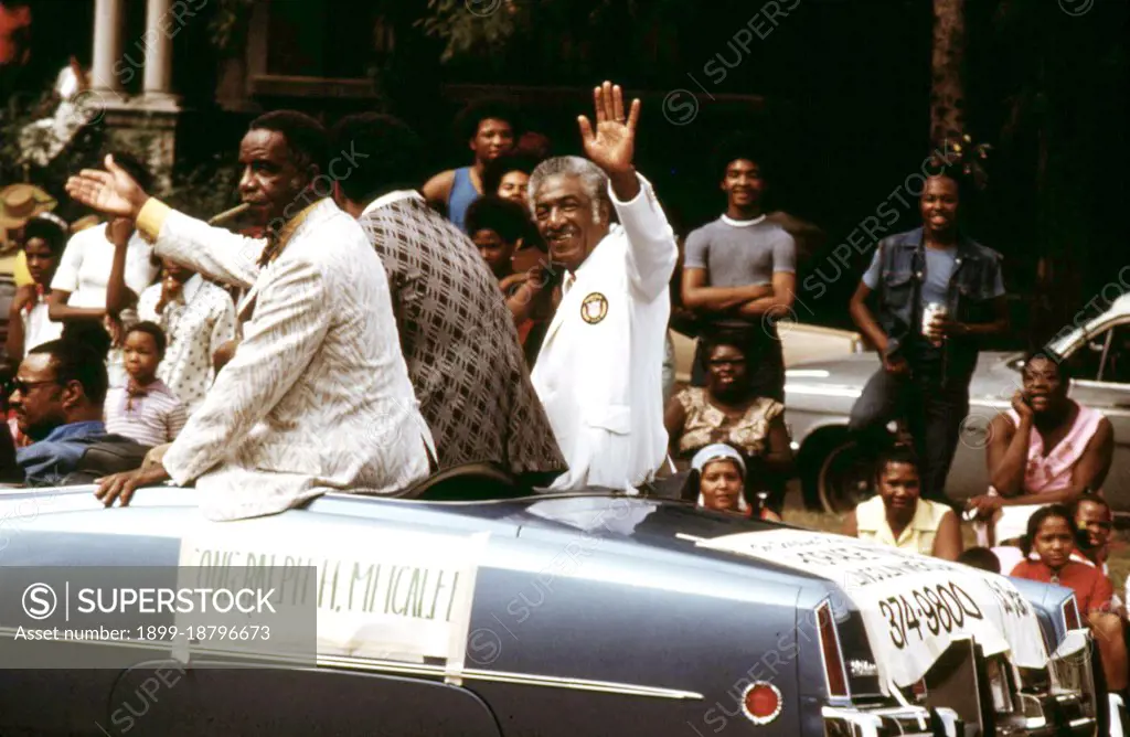 1973 - Illinois Congressman Ralph H. Metcalfe (White Coat) Greeting Constituents During The Bud Billiken Day Parade, 08/1973. 