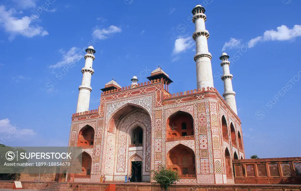 The Tomb of the the third Mughal Emperor Akbar (r. 1556-1605) is an important Mughal architectural masterpiece, built 1605-1613 and set in 48 Ha (119 acres) of grounds in Sikandra, a suburb of Agra, Uttar Pradesh, India. Emperor Akbar himself commenced its construction around 1600, according to Central Asian tradition to commence the construction of one's tomb during one's lifetime. Akbar himself planned his own tomb and selected a suitable site for it, after his death, Akbar's son Jahangir completed the construction in 1605-1613. The south gate is the largest, with four white marble chhatri-topped minarets which are similar to (and pre-date) those of the Taj Mahal, and is the normal point of entry to the tomb. The tomb itself is surrounded by a walled enclosure 105 m square. The tomb building is a four-tiered pyramid, surmounted by a marble pavilion containing the false tomb. The true tomb, as in other Mughal mausoleums, is in the basement. The buildings are constructed mainly from a 