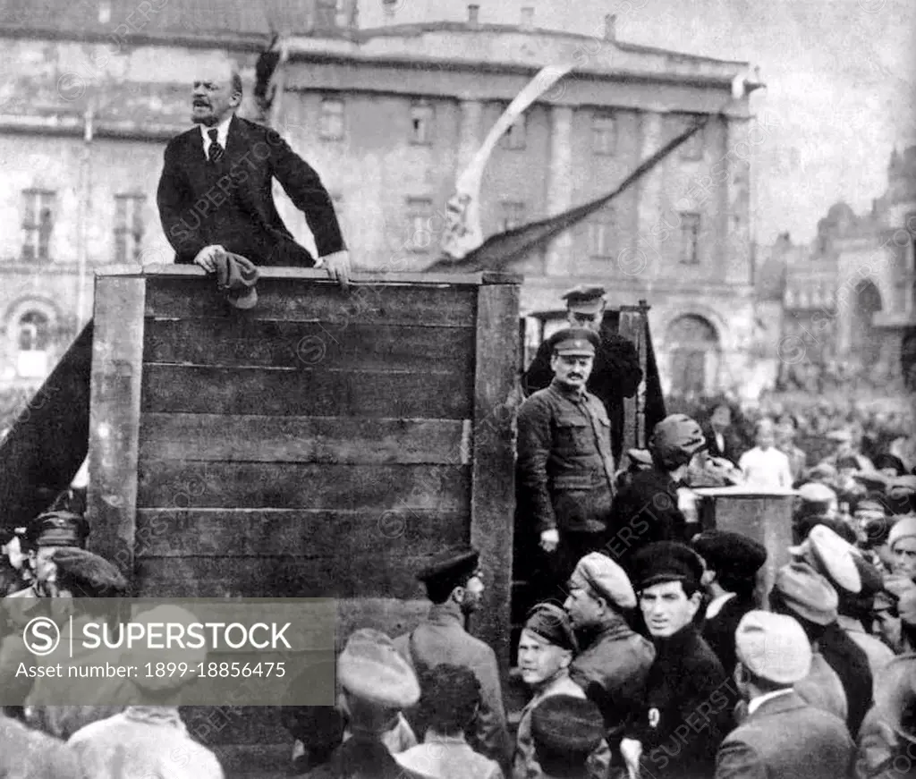 Lenin speaking at an assemble of Red Army troops bound for the Polish front. Photograph taken in Sverdlov Square, Moscow, on 5 May 1920. This is the original image with Trotsky and Kamenev standing on the steps of the platform; later versions produced under Stalin's administration had them removed.