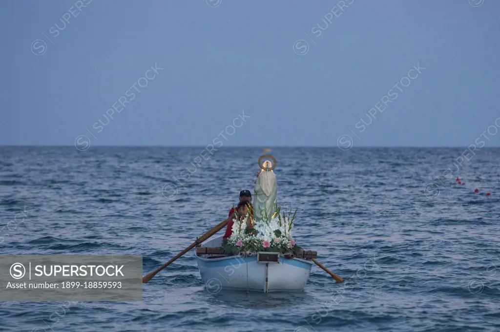 During the procession of the Madonna della Neve on 5 August the statue of the Madonna is taken by rowing boat to the Natarella beach. Savona; Liguria; Italy