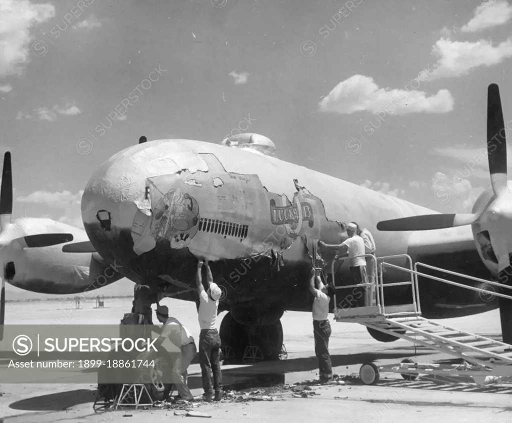 A reconditioning crew peel off the "cocoon" encasing a B-29 bomber stored at an airfield somewhere in the southwestern United States, in preparation for the aircraft's return to duty in the Korean War, Southwestern United States, 1950. (Photo by United States Information Agency/GG Vintage Images)