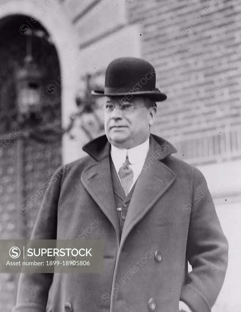 Hiram W. Johnson, half-length portrait, standing, facing left, wearing bowler hat ca. 1909.