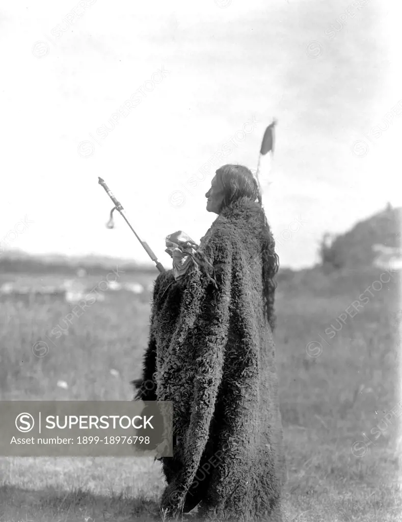 Edward S. Curits Native American Indians - Photograph shows Saliva, an Oglala Sioux priest, dressed for the Hu Kalowa Pi ceremony ca. 1907. 