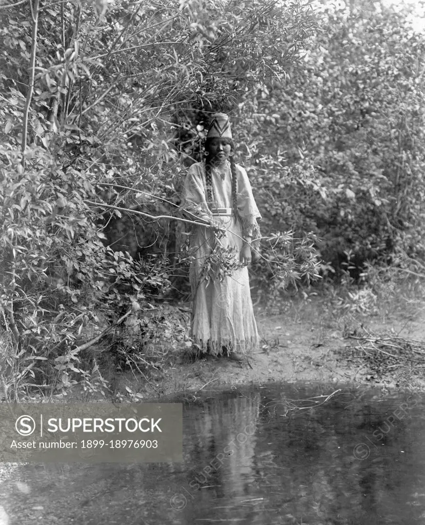 Edward S. Curtis Native American Indians -  Nespelim woman standing at water's edge ca. 1905. 