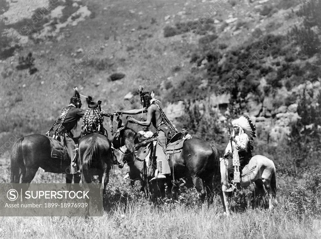 Edward S. Curtis Native American Indians -  Crow men on horseback apparently involved in an exchange ca. 1905. 