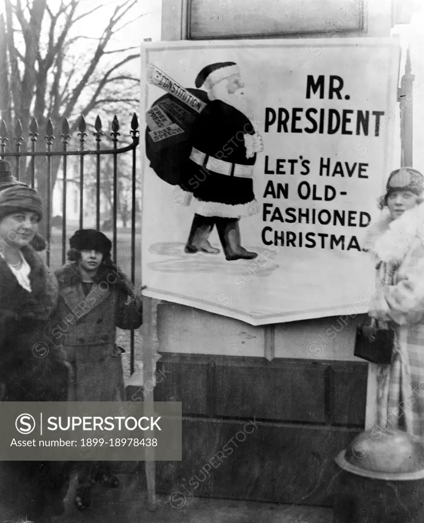 The demonstrators' sign says, 'Mr. President, let's have an old-fashioned Christmas,' and shows Santa Claus carrying a bag of gifts including, the Constitution, Free Assemblage, Free Speech, and Free Press. 