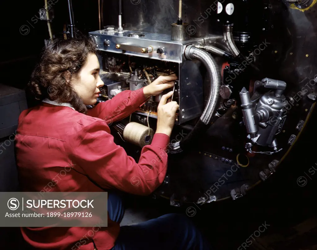 Switch boxes on the firewalls of B-25 bombers are assembled by women workers at North American Aviation, Inc.'s Inglewood, Calif., plant - October 1942. 