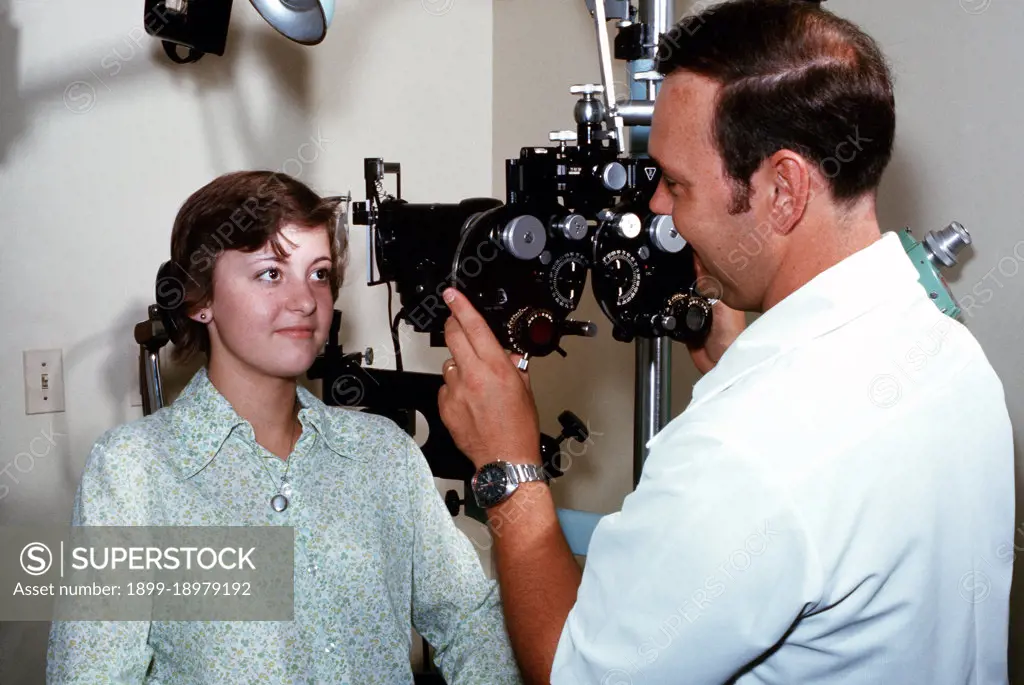 1976 - A female has her eyes checked by a doctor who is using an Ophthalmoscope. 