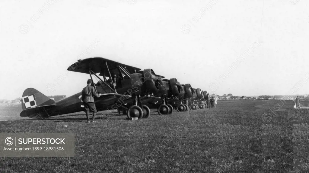 PWS-26 aircraft in CWOL. Commander of the Aviation Officers Training Center in Dblin Lt. Col. Stefan Sznuk (in the distance) releases the first PWS 26 aircraft ca. May 1937. 