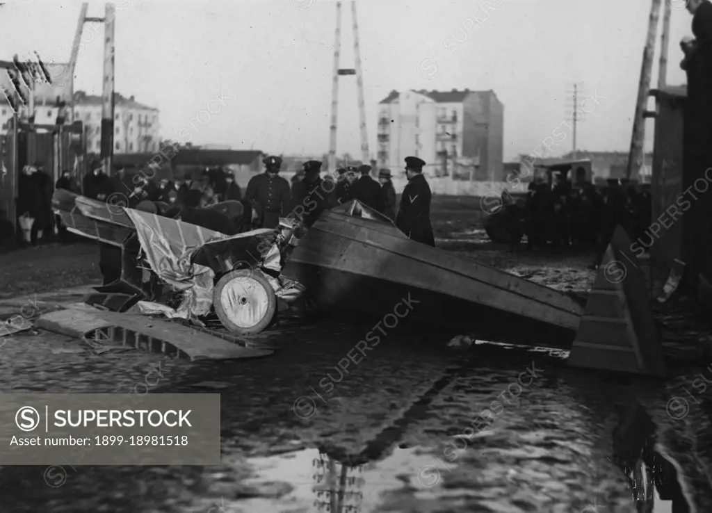 Soldiers or police looking over remains of an airplane crash in Poland ca. 1931. 