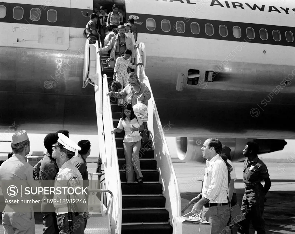 1975 - Vietnamese refugees arrive at the air station after being evacuated from Saigon.  . 