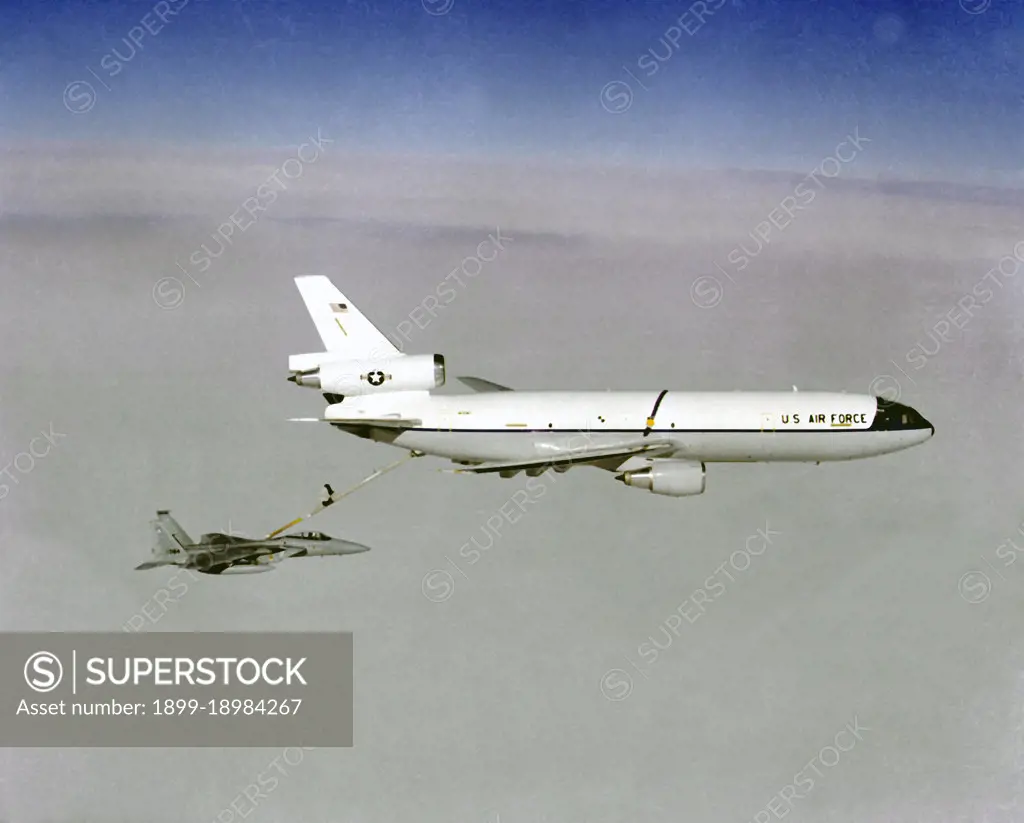 Air-to-air right side view of a KC-10A Extender aircraft refueling an F-15A Eagle aircraft.. 