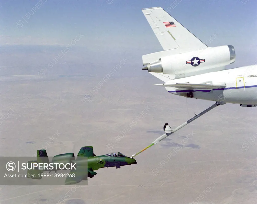 An overhead right side view of an A-10A Thunderbolt aircraft undergoing in-flight refueling through the boom of a KC-10A Extender aircraft.. 