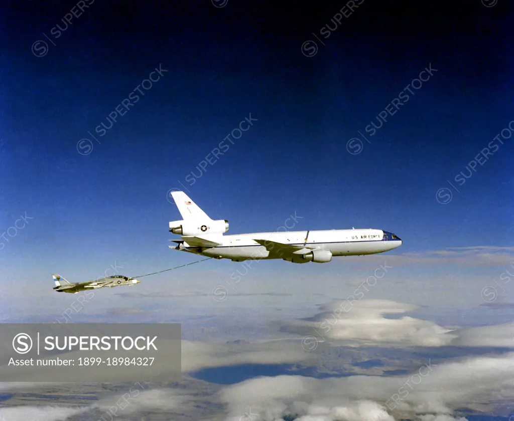 1982 - Air-to-air right side view of a KC-10A Extender aircraft refueling an F-14 Tomcat aircraft.. 